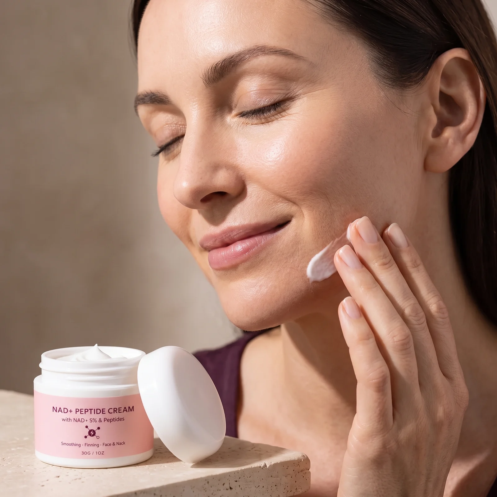 Woman smoothing Nadora cream onto her cheek